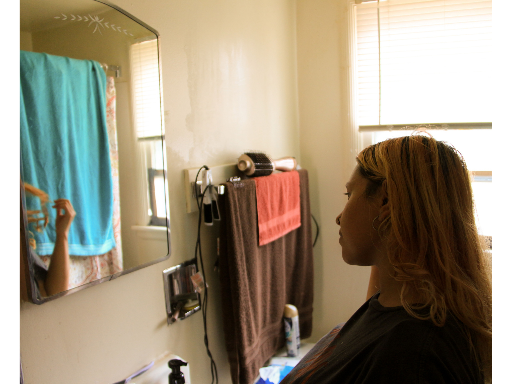 Woman looking at herself in the mirror